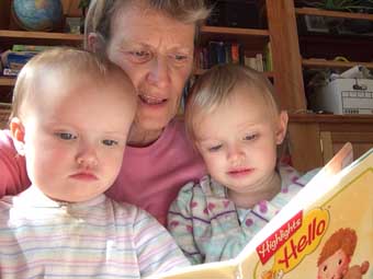 Patty reads to twins